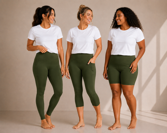 Three women wearing Barefoot & Busy Olive Grove leggings, capri leggings and shorts with a white t-shirt in a studio setting